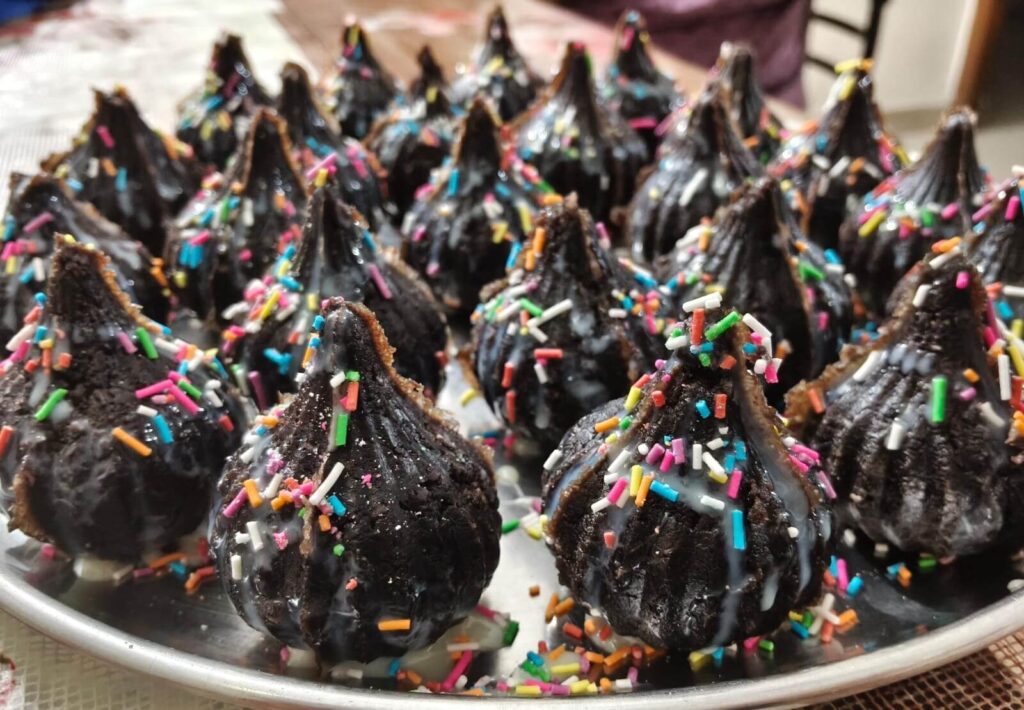 Fresh Chocolate Modak coated with colorful sprinkles, perfect for festive celebrations and sweet cravings.