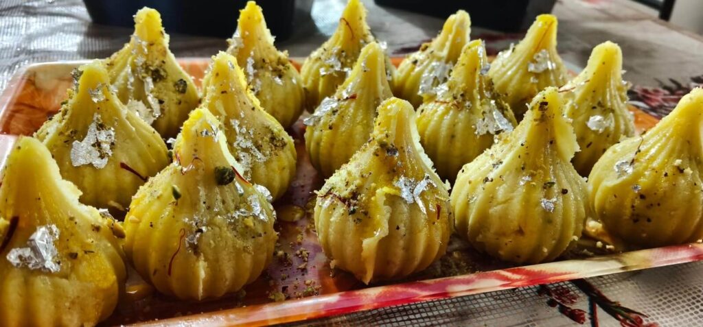 Fresh Kesar Pista Dry Fruit Modak with rich saffron flavor, pistachios, and a touch of edible silver leaf.
